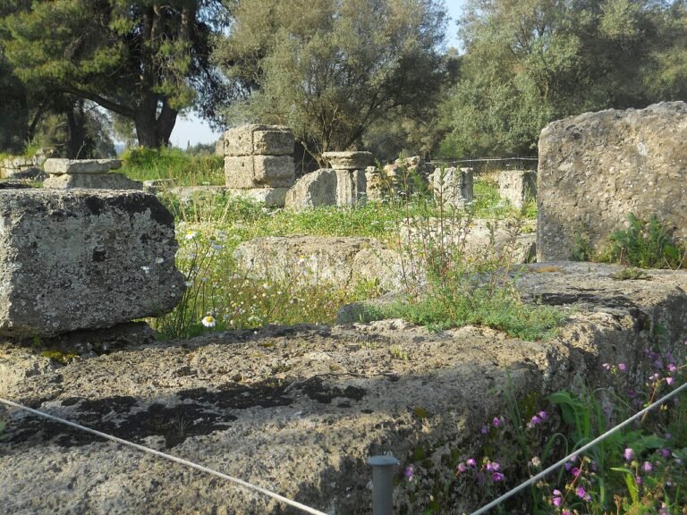 Archaeological ruins at Ancient Olympia with fallen columns and excavated foundations of the Olympic sanctuary