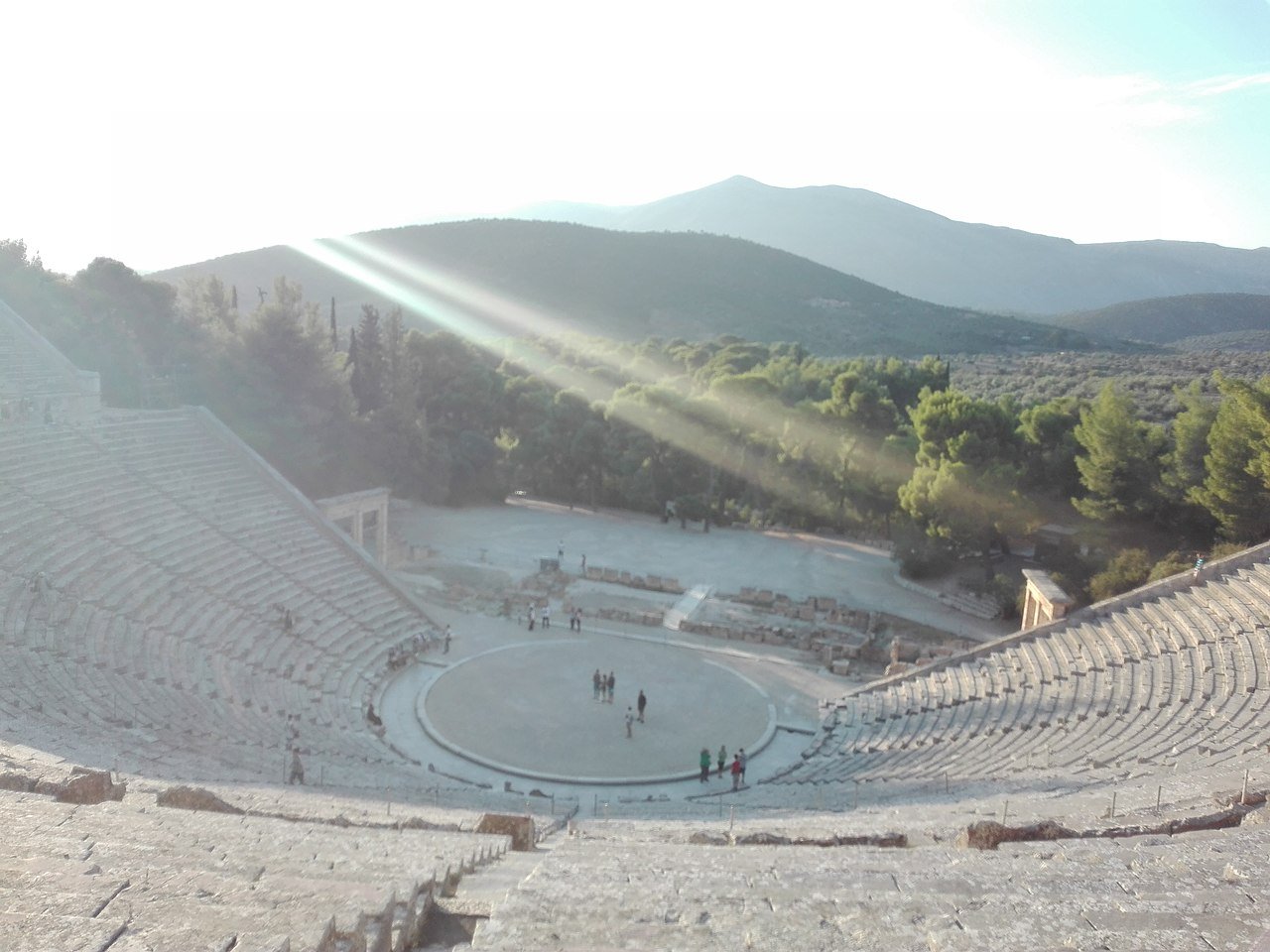 Ancient Theatre of Epidaurus viewed from upper tiers showing circular orchestra and stone seating for 14000 spectators