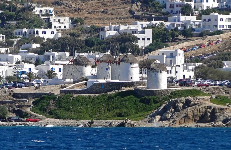 Famous white windmills on hill in Mykonos with Aegean Sea view