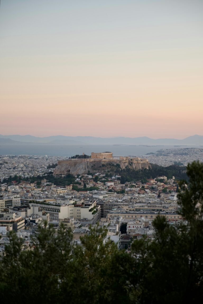 Athens airport transfer to Divani Palace Acropolis hotel — Acropolis at sunset overlooking Athens